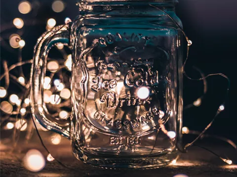 A glass bottle with fairy lights